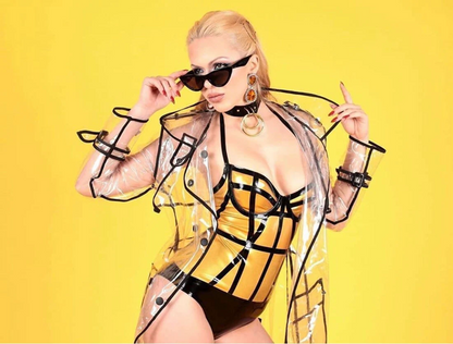 Person wearing a transparent raincoat with black accents on a yellow background