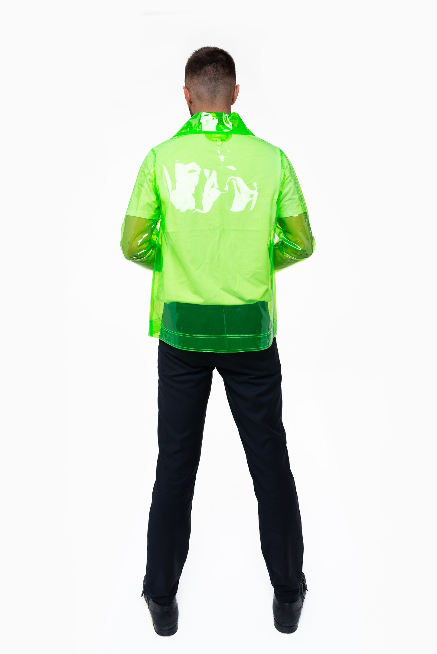 Person wearing a transparent neon green blazer on a white background back view