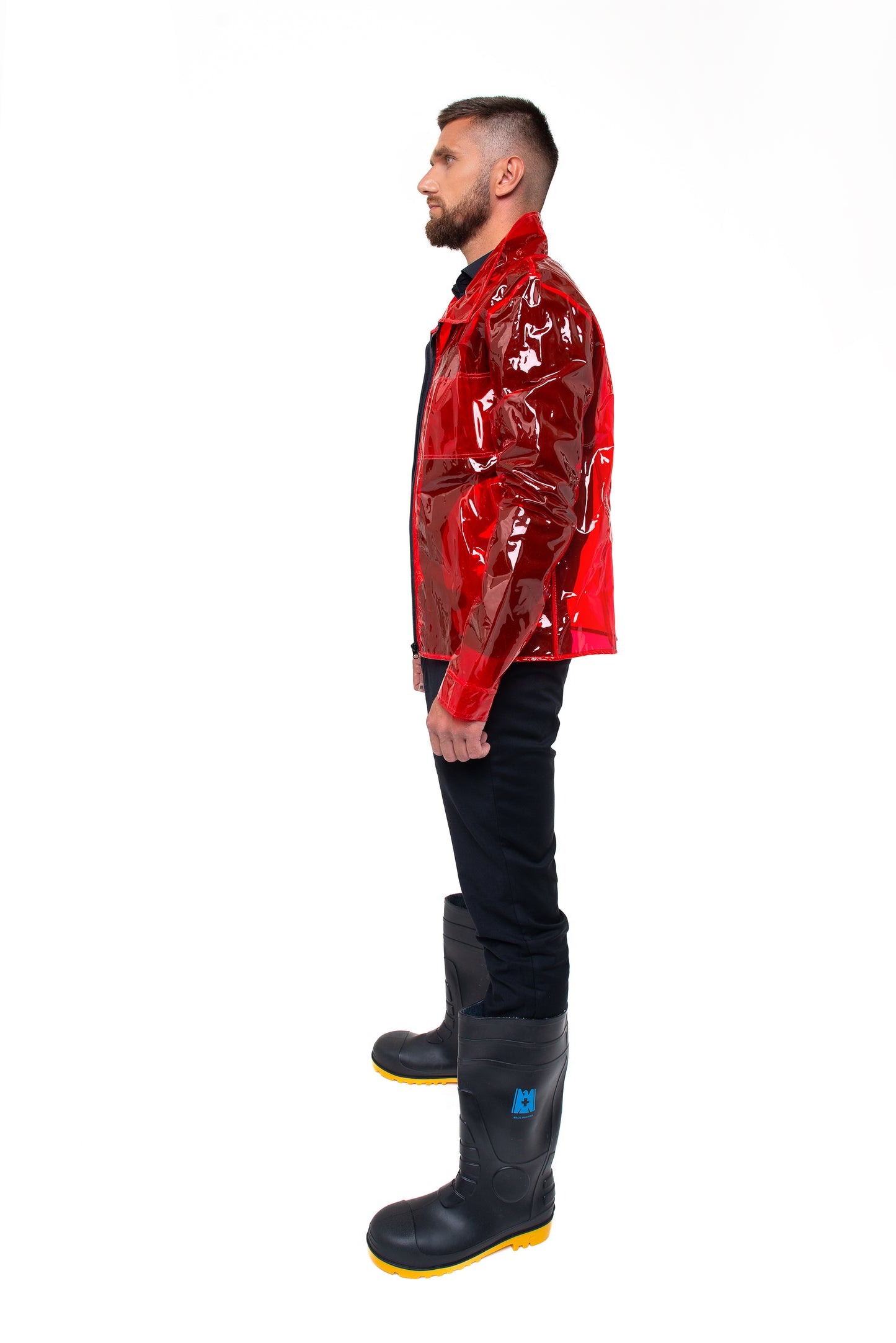 Model wearing a futuristic red waterproof blazer in an urban sryle
