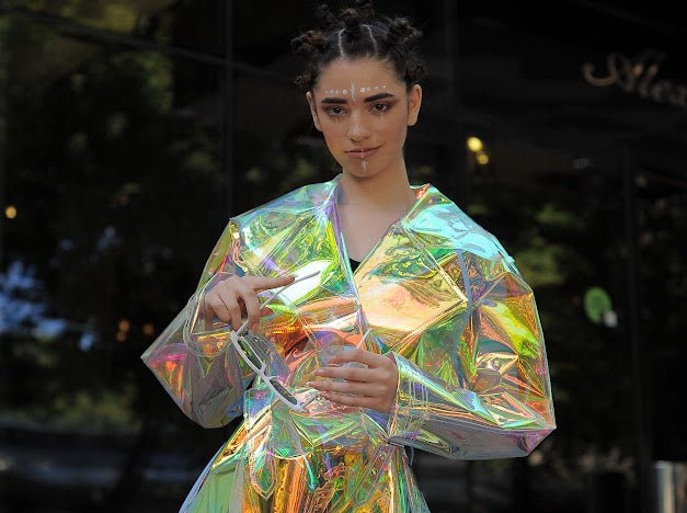 Futuristic longline iridescent jacket from the holographic vinyl trench coat collection.
