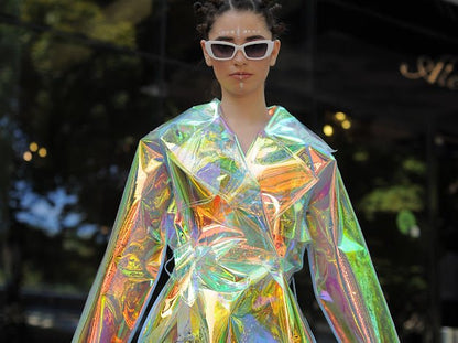Futuristic longline iridescent jacket from the holographic vinyl trench coat collection.