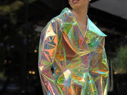 Model wearing the holographic vinyl trench coat iridescent festival outfit by Domdrich.