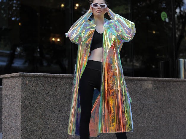 Model wearing the holographic vinyl trench coat iridescent festival outfit by Domdrich.