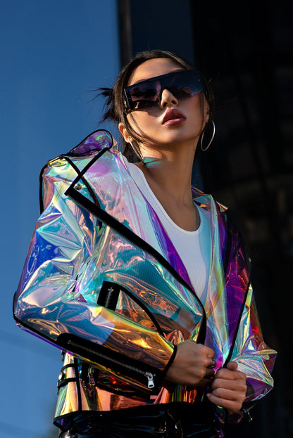 Model wearing a holographic biker jacket with a rainbow iridescent effect by Domdrich