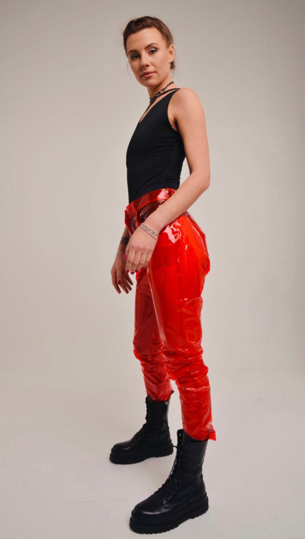 Side view of high-waisted transparent TPU pants showing the straight-leg fit.