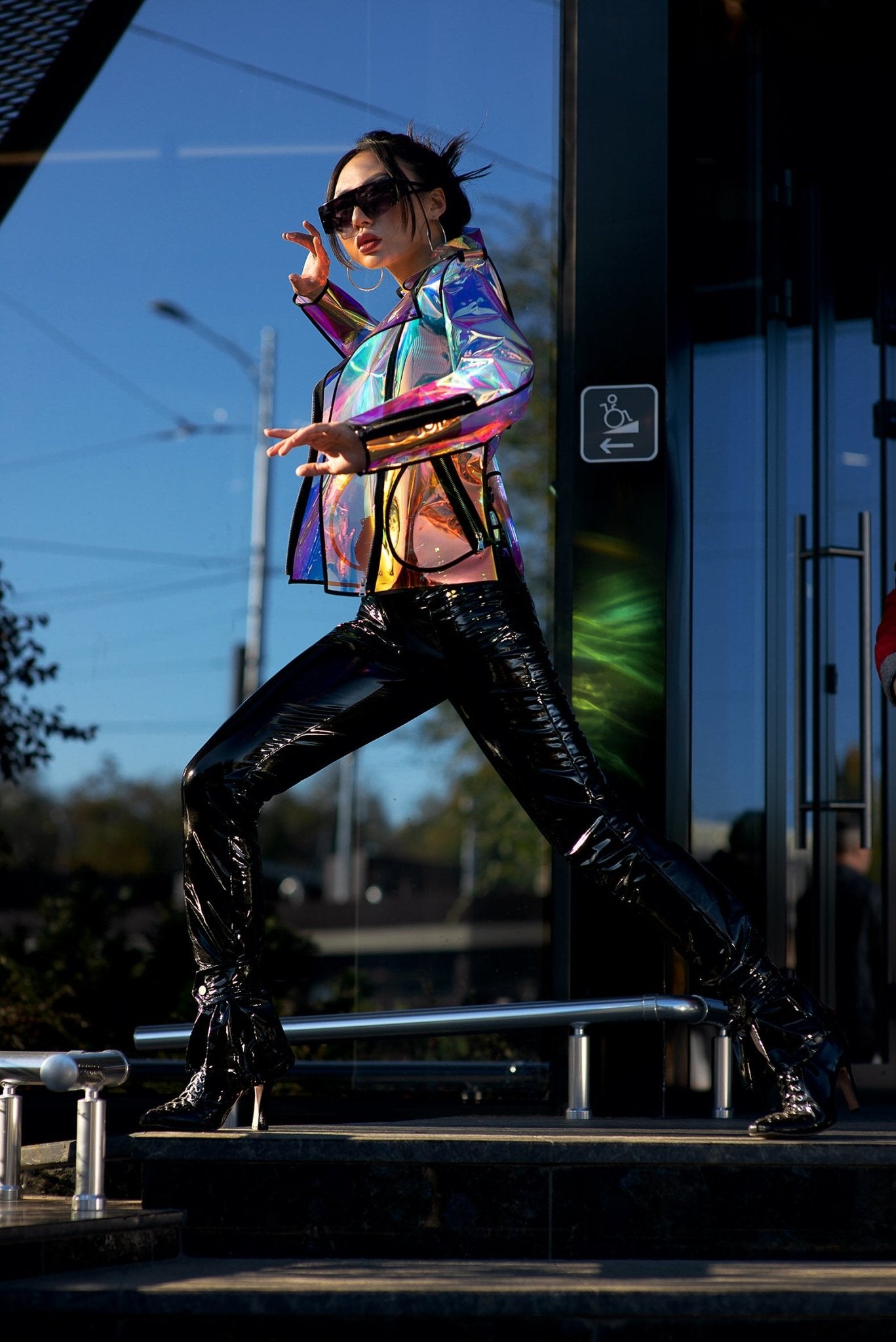 Action shot showing the color-shifting glow of the holographic TPU jacket.