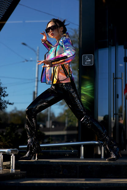 Action shot showing the color-shifting glow of the holographic TPU jacket.